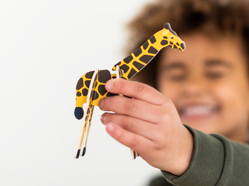 Child holding up a Playpress Giraffe