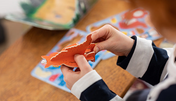 A child playing with the Zog playset